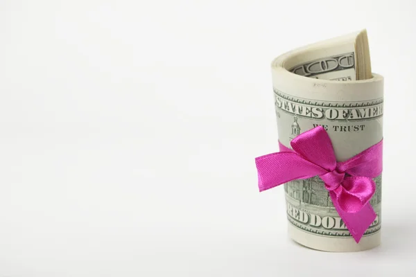 US dollar wrapped by purple ribbon Stock Photo