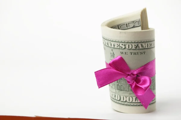 US dollar wrapped by purple ribbon Stock Picture