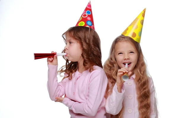 Party girls blowing noisemakers — Stock Photo, Image