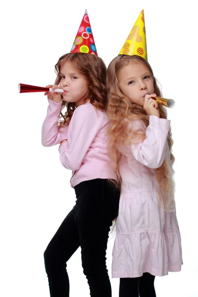 Party girls blowing noisemakers — Stock Photo, Image