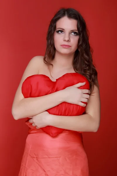 Girl in red dress with symbol of heart — Stock Photo, Image