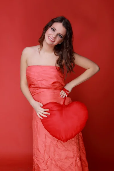 Girl in red dress with symbol of heart — Stock Photo, Image