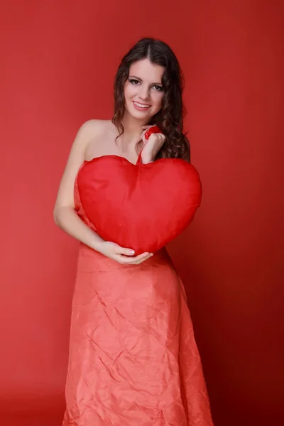 Girl in red dress with symbol of heart — Stock Photo, Image