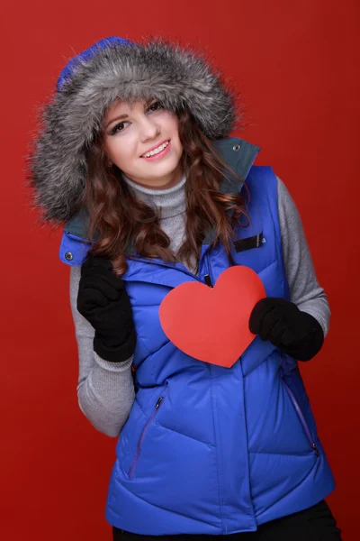 Warmly dressed girl with a heart in his hands — Stock Photo, Image