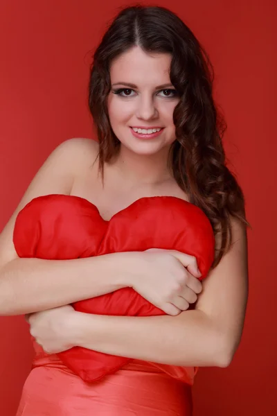 Girl in red dress with symbol of heart — Stock Photo, Image