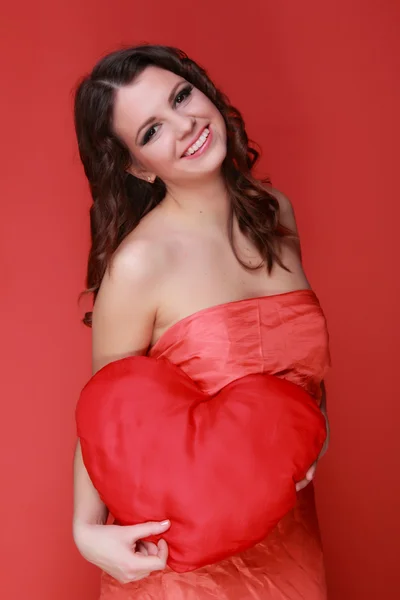 Girl in red dress with symbol of heart — Stock Photo, Image