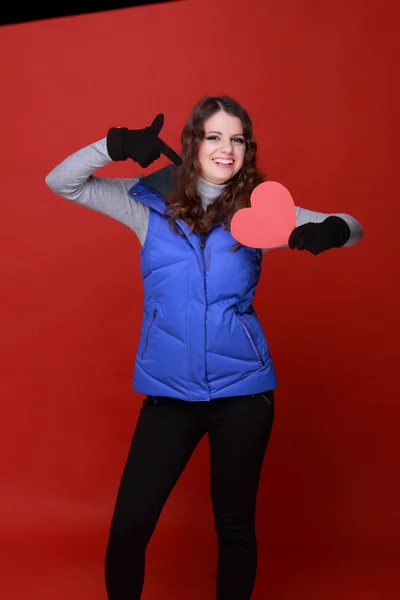 Warmly dressed girl with a heart in his hands — Stock Photo, Image