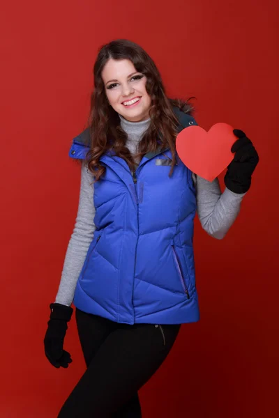 Warmly dressed girl with a heart in his hands — Stock Photo, Image