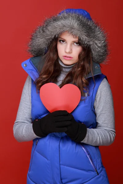 Warmly dressed girl with a heart in his hands — Stock Photo, Image