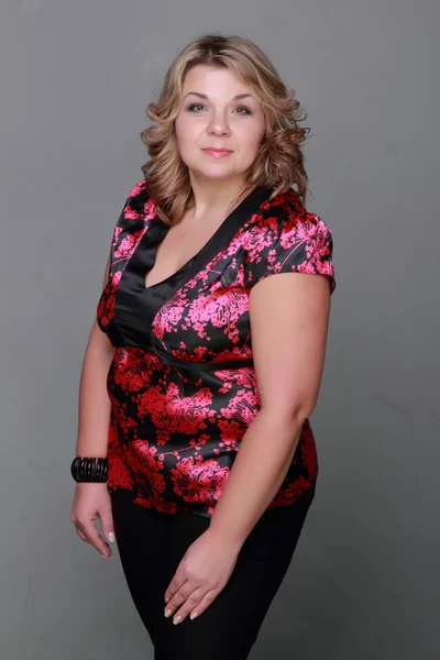 Woman in a floral blouse — Stock Photo, Image