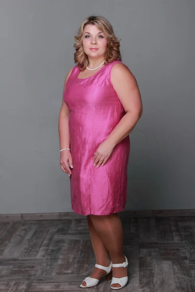 Beautiful woman in a pink dress — Stock Photo, Image