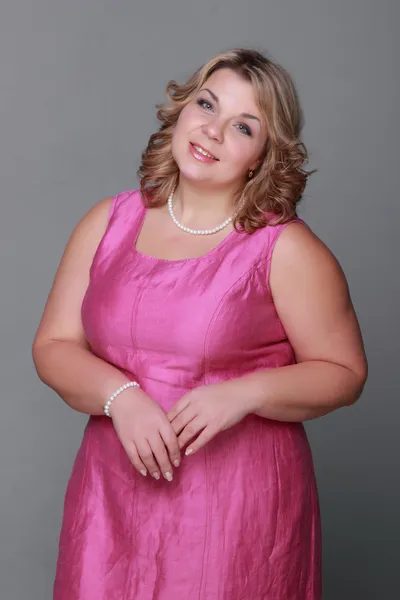 Beautiful woman in a pink dress — Stock Photo, Image