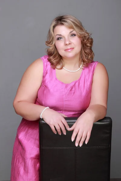 Beautiful woman in a pink dress — Stock Photo, Image