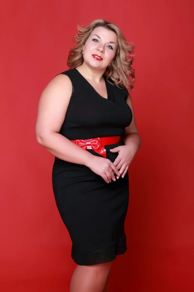 Portrait of a beautiful woman on a red background — Stock Photo, Image