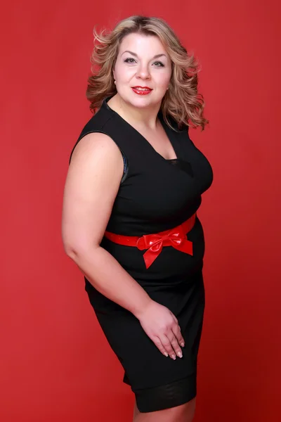 Portrait of a beautiful woman on a red background — Stock Photo, Image