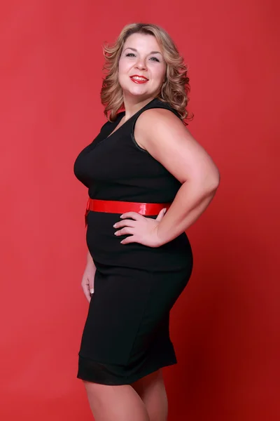 Portrait of a beautiful woman on a red background — Stock Photo, Image