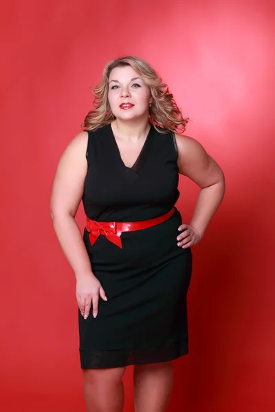 Portrait of a beautiful woman on a red background — Stock Photo, Image