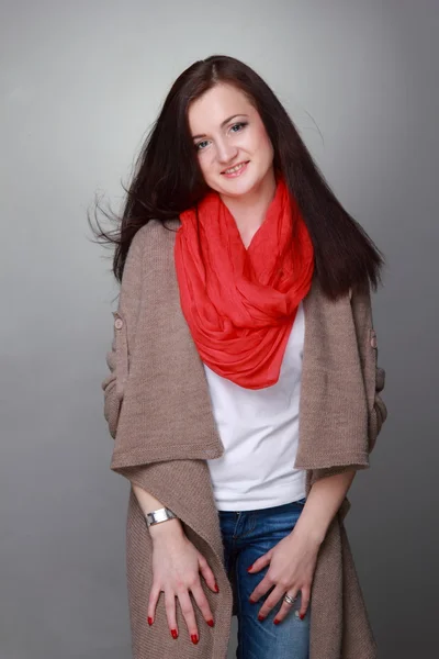 Beautiful girl with a red scarf — Stock Photo, Image