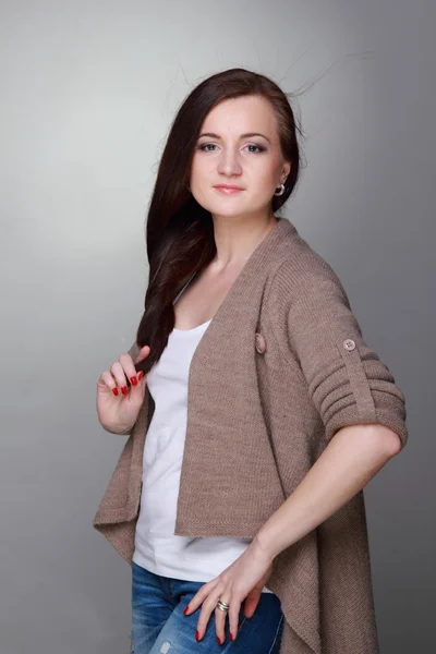 Attractive girl on a grey background — Stock Photo, Image