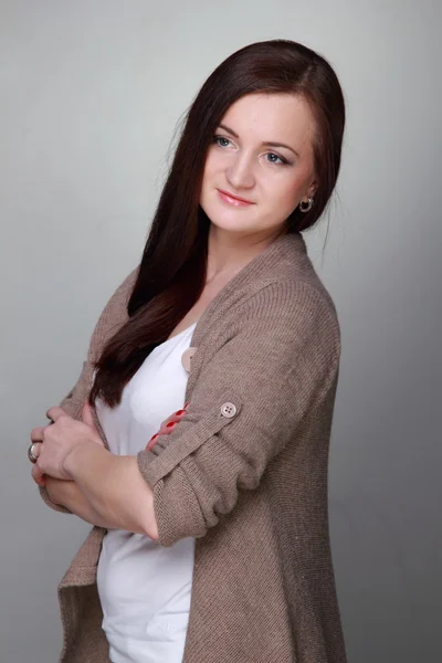 Attractive girl on a grey background — Stock Photo, Image