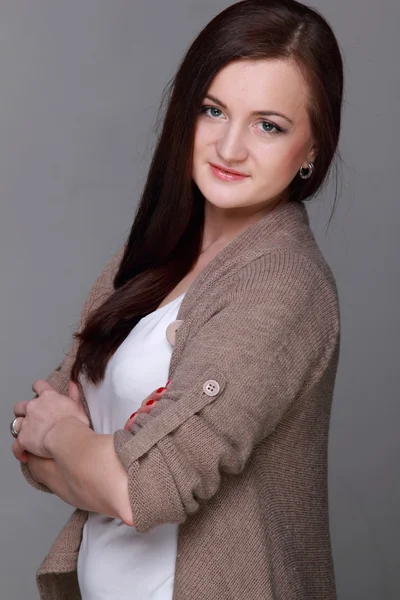 Attractive girl on a grey background — Stock Photo, Image