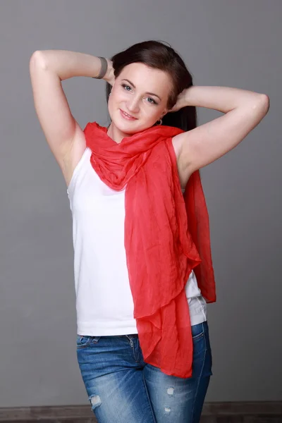 Beautiful girl with a red scarf — Stock Photo, Image