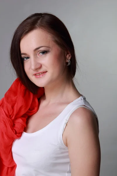 Beautiful girl with a red scarf — Stock Photo, Image