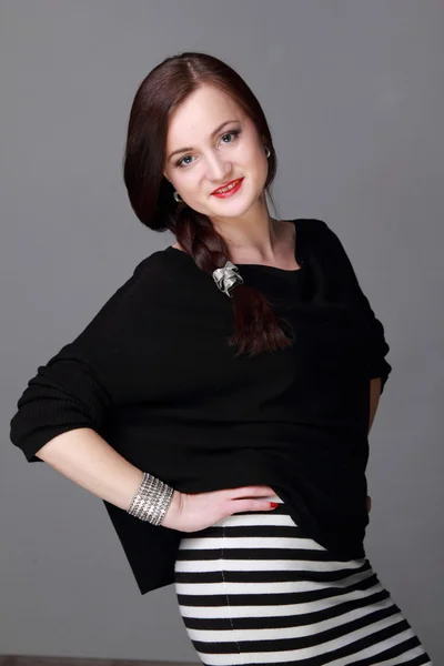 Portrait of a beautiful girl in a striped skirt — Stock Photo, Image