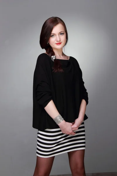 Portrait of a beautiful girl in a striped skirt — Stock Photo, Image