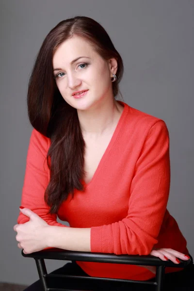 Beautiful girl posing on the chair — Stock Photo, Image