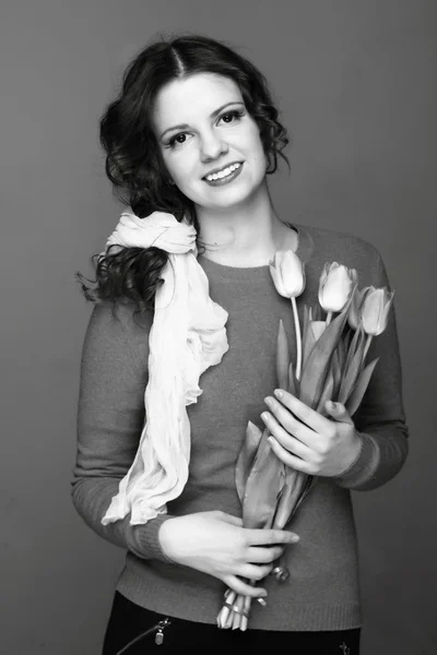 Black-and-white portrait of a girl with tulips