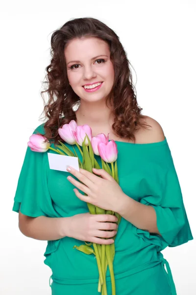 Žena s vizitka a tulipány — Stock fotografie
