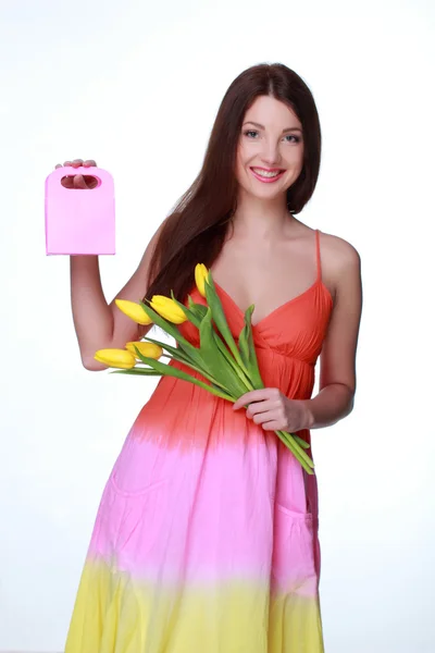 Happy girl with yellow tulips and gift — Stock Photo, Image