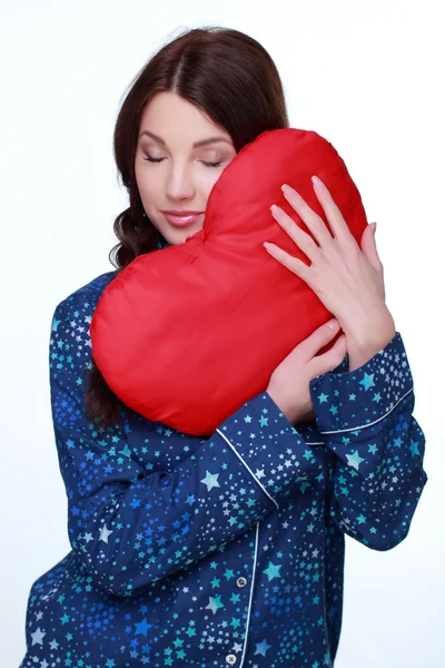 Girl with heart shape pillow — Stock Photo, Image