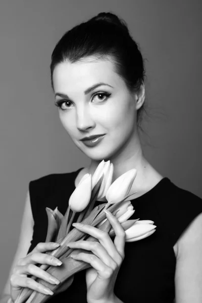 Black and white portrait of a girl with tulips — Stock Photo, Image