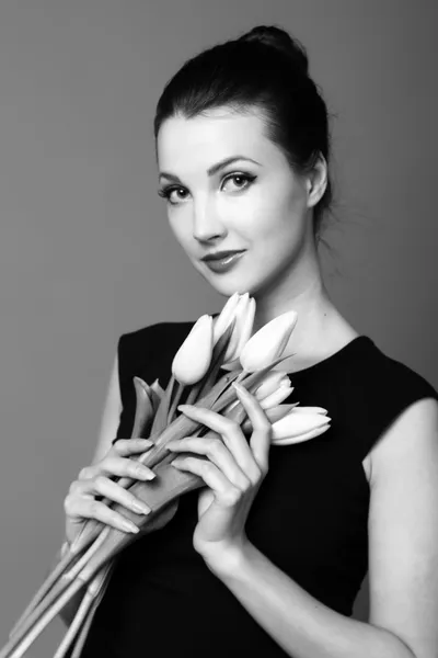 Black and white portrait of a girl with tulips — Stock Photo, Image