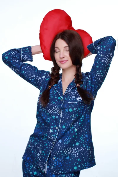 Picture of happy and smiling woman with heart-shaped pillow — Stock Photo, Image