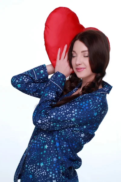Picture of happy and smiling woman with heart-shaped pillow — Stock Photo, Image