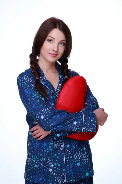 Picture of happy and smiling woman with heart-shaped pillow — Stock Photo, Image