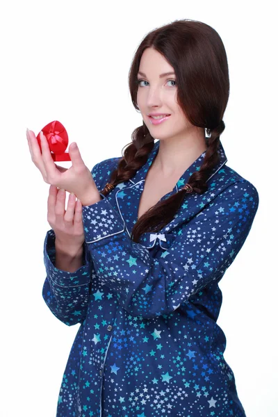 Beautiful girl in pajamas considering a gift — Stock Photo, Image