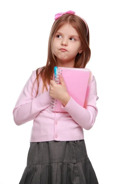 Küçük kız öğrenci holding renkli kalemler ve kopya-kitap — Stok fotoğraf