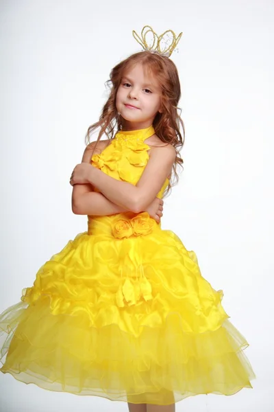 Little girl in a yellow dress and a crown — Stock Photo, Image