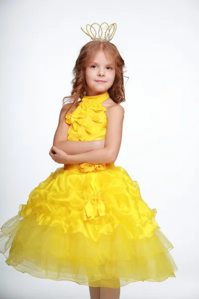 Little girl in a yellow dress and a crown — Stock Photo, Image