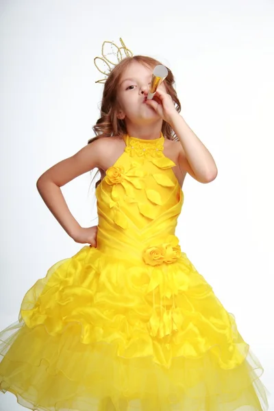 Little girl in a yellow dress and a crown — Stock Photo, Image