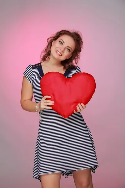 Vacker kvinna i en randig klänning med ett stort hjärta — Stockfoto