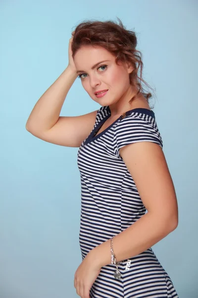 Beautiful woman in a striped dress — Stock Photo, Image