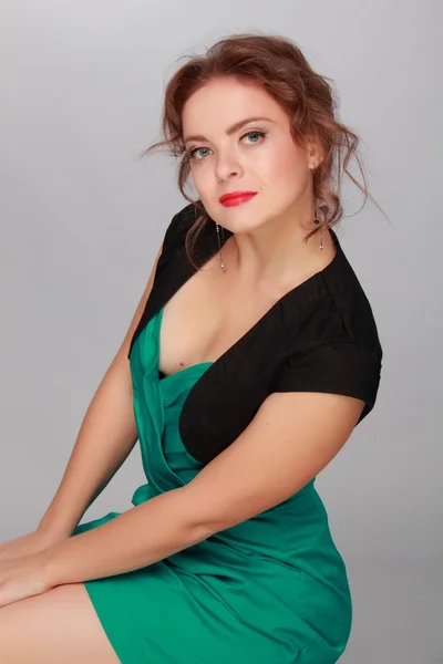 Beautiful woman in a green dress — Stock Photo, Image
