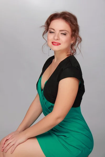 Beautiful woman in a short green dress — Stock Photo, Image