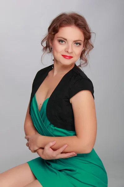 Beautiful woman in a short green dress — Stock Photo, Image