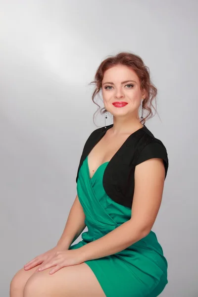 Beautiful woman in a green dress — Stock Photo, Image